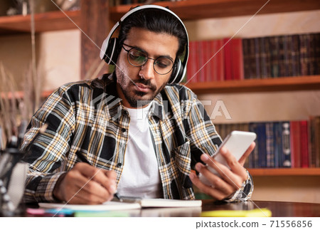 Indian Student Guy Using Smartphone Learning In University Library Indian Student Guy Using Smartphone Learning In University Library 71556856