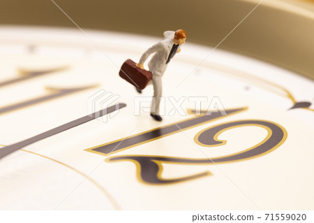 A businessman running with a clock A businessman running with a clock 71559020