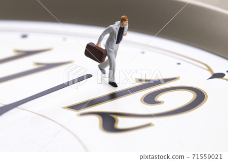 A businessman running with a clock 71559021