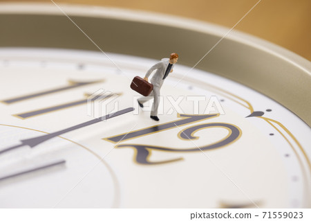 A businessman running with a clock 71559023