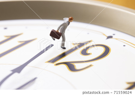 A businessman running with a clock 71559024