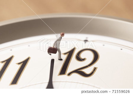 A businessman running with a clock 71559026