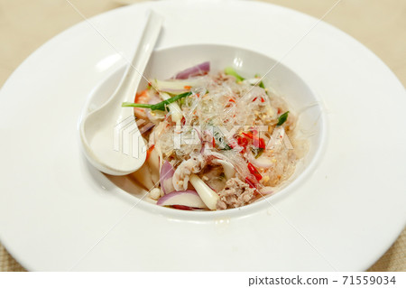Spicy Glass Noodle Salad with Squid on white plate. Spicy Glass Noodle Salad with Squid on white plate. 71559034