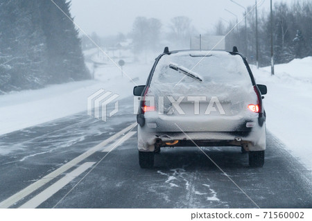 Car is driving on a winter road  71560002