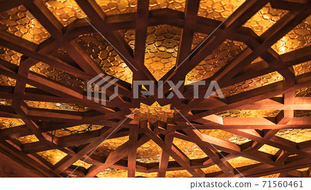 Beautiful vintage lamp of wood and golden metal in a cafe. 71560461