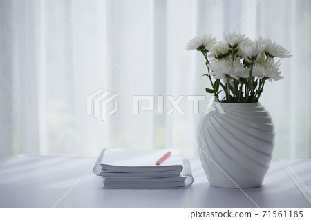 White Chrysanthemum and white notebook with red pencil on wooden table White Chrysanthemum and white notebook with red pencil on wooden table 71561185