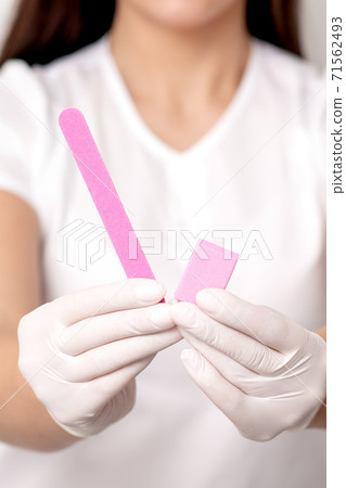 Manicure tools in hands of manicurist Manicure tools in hands of manicurist 71562493