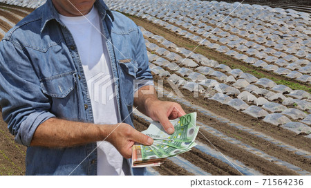Agricultural concept, farmer, money and field with greenhouses Agricultural concept, farmer, money and field with greenhouses 71564236