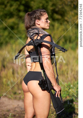 female hunter in camouflage waiting for opportunities to shoot 71564248