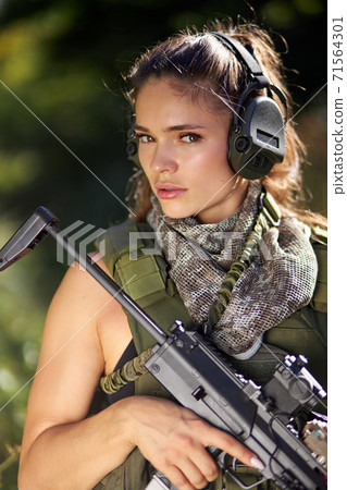 portrait of good-looking caucasian female with rifle in hands 71564301