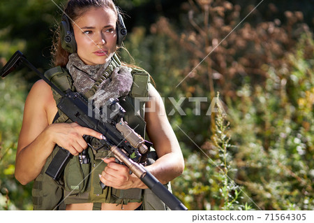female hunter in camouflage waiting for opportunities to shoot 71564305