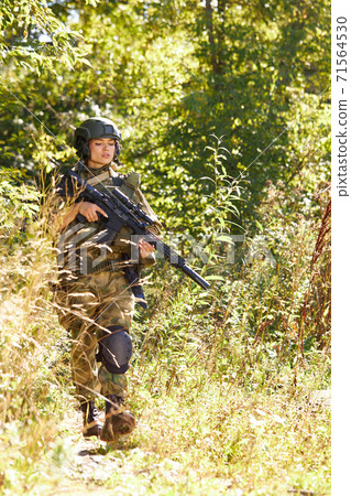 brave caucasian woman is engaged in hunting weapon gun or rifle brave caucasian woman is engaged in hunting weapon gun or rifle 71564530