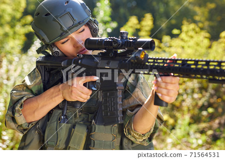 sportive woman soldier shooting with rifle machine gun in the forest sportive woman soldier shooting with rifle machine gun in the forest 71564531