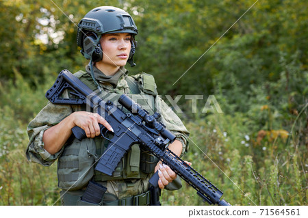 powerful sportive woman soldier ready for battle wearing protective military gear 71564561