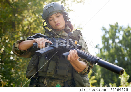 military woman is checking details of weapon military woman is checking details of weapon 71564576