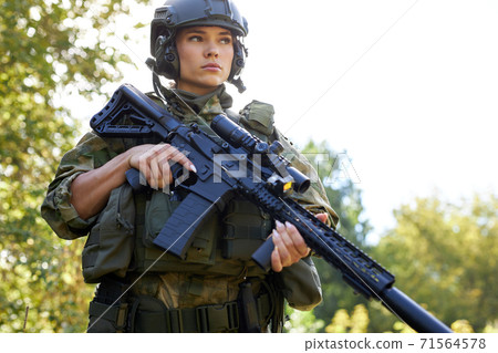 brave caucasian woman is engaged in hunting weapon gun or rifle brave caucasian woman is engaged in hunting weapon gun or rifle 71564578