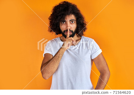 indian arabic male asking to be quiet with finger on lips indian arabic male asking to be quiet with finger on lips 71564620