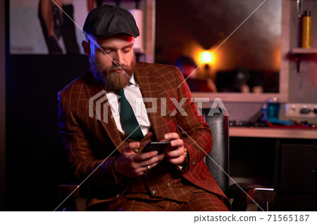 serious business man in suit using smartphone 71565187