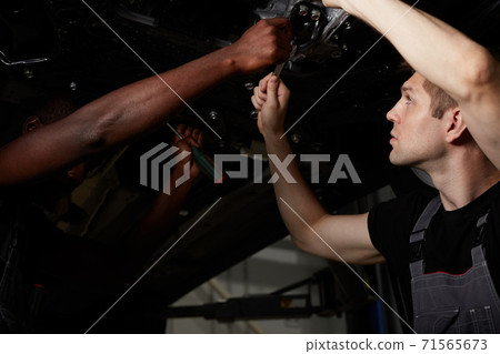 two friendly professional auto mechanic during work 71565673