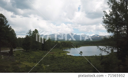Small mountain lake with blue water and green trees. Scene. Aerial View. Drone shot. The concept of a healthy country life, clean air, natural nature 71565932