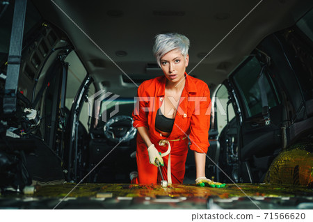 Work in a car service. Car soundproofing process Work in a car service. Car soundproofing process 71566620