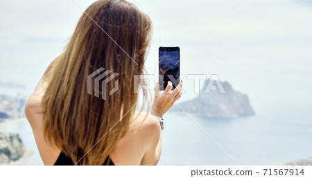 Woman admire view through smartphone Woman admire view through smartphone 71567914