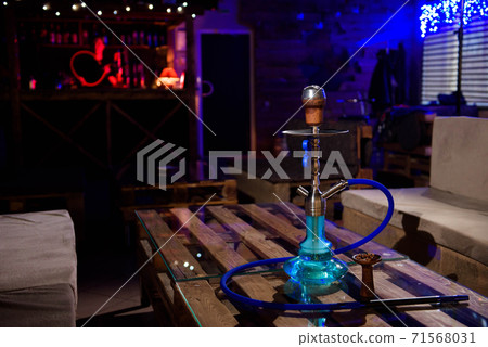 Hookah on the background of a bar, light, smoke, smog Hookah on the background of a bar, light, smoke, smog 71568031