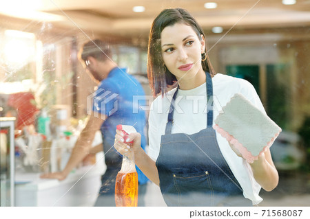 Barista wiping glass cafe walls Barista wiping glass cafe walls 71568087