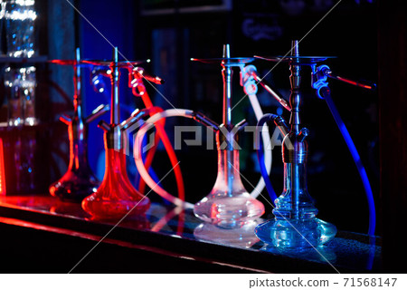 Multicolored hookah in the restaurant. Hookah elements on the background of the restaurant. 71568147
