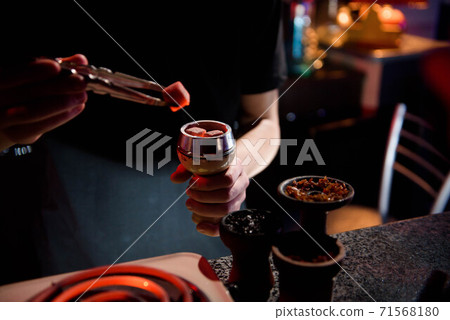 Shisha hookah with red hot coals. Modern hookah with coconut charcoal for relax and shisha smoke. Hookah and sparks from coals. Shisha hookah with red hot coals. Modern hookah with coconut charcoal for relax and shisha smoke. Hookah and sparks from coals. 71568180