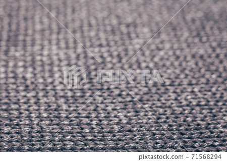 Blurred abstract background of grey knitted fabric made of silvery yarn. Blurred abstract background of grey knitted fabric made of silvery yarn. 71568294