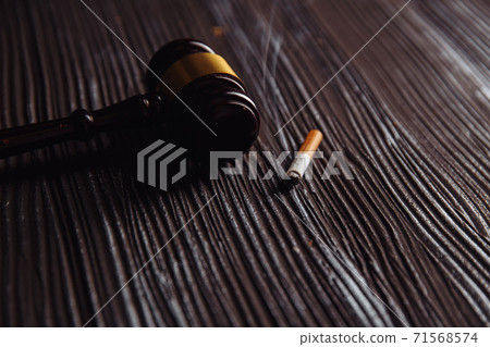 Judge gavel and smoking cigarette on a table. Tobacco law Judge gavel and smoking cigarette on a table. Tobacco law 71568574