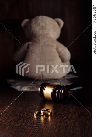 Alimony payment. Dollar banknotes, wooden judge gavel with rings and teddy bear close-up. Divorce and alimony concept 71568584