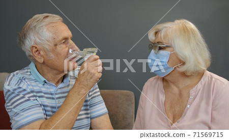Senior couple grandfather and grandmother monitoring oxygen saturation. Breathing device to breathe Senior couple grandfather and grandmother monitoring oxygen saturation. Breathing device to breathe 71569715