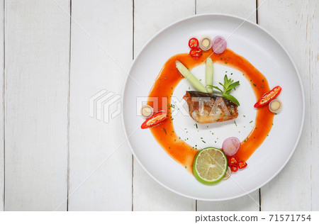 Spicy Salad with canned sardine fish in white dish on wooden floor. 71571754