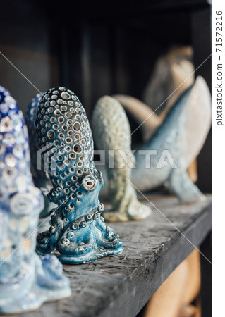 Finished pottery stands on a shelf in a pottery workshop 71572216