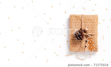 Gift box wrapped in craft paper with decor 71575018