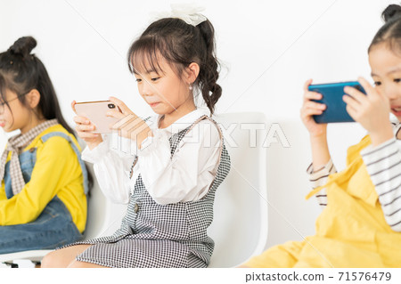 Children using smartphone Children using smartphone 71576479