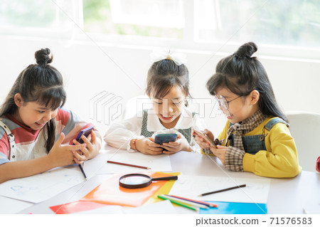 Children using smartphone 71576583