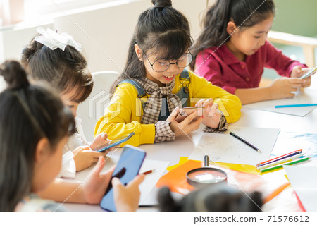 Children using smartphone 71576612