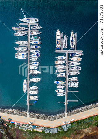 The drone aerial view of sailing yachts moored in marina Quinta do Lorde on coast of the Portuguese island of Madeira 71578932
