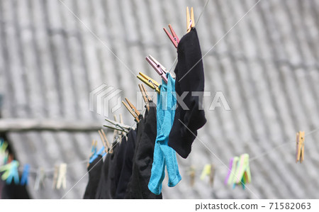 Colorful laundry hanging on the rope outdoors Colorful laundry hanging on the rope outdoors 71582063