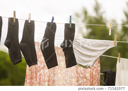 Colorful laundry hanging on the rope outdoors Colorful laundry hanging on the rope outdoors 71582077