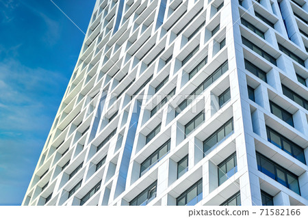 Exterior of modern multistory building against cloudy sky Exterior of modern multistory building against cloudy sky 71582166