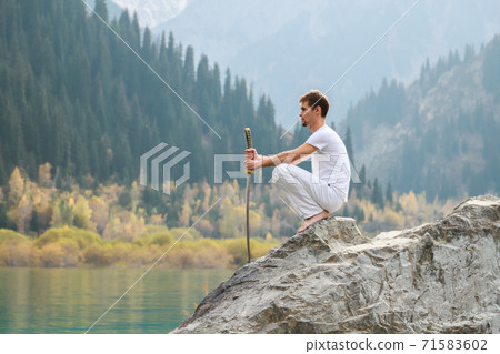 A man with a beard lowered his battle sword. Male defeat. 71583602