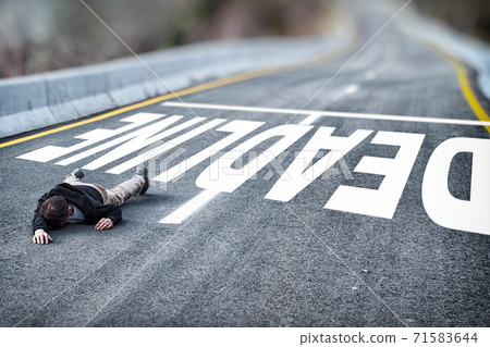 Tired powerless man in black jacket and grey trousers fallen on road overcome deadline title written on asphalt 71583644