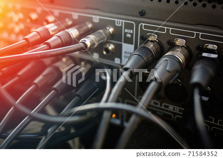 Close up audio jacks cable plugged into mixer console. XLR audio cable. Close up audio jacks cable plugged into mixer console. XLR audio cable. 71584352