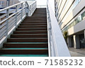 A pedestrian bridge connecting the roads, stairs with a handrail on one side 71585232
