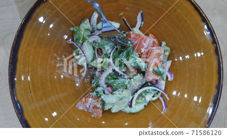 Customer guest eats green vegetable salad in restaurant or cafe. Top of view 71586120