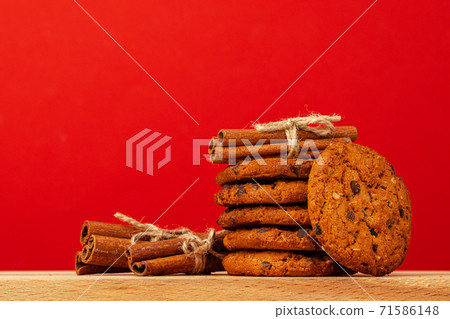 Chocolate chip cookies in stack on red background 71586148